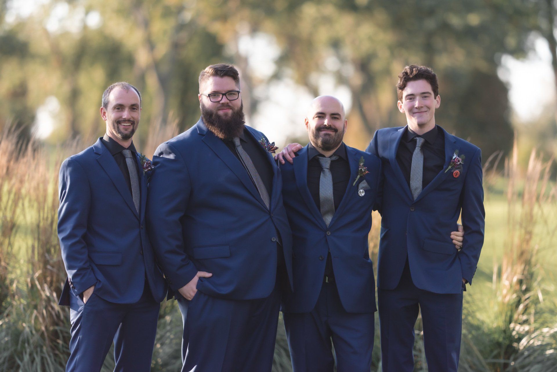 A group of men in suits and ties are posing for a picture.