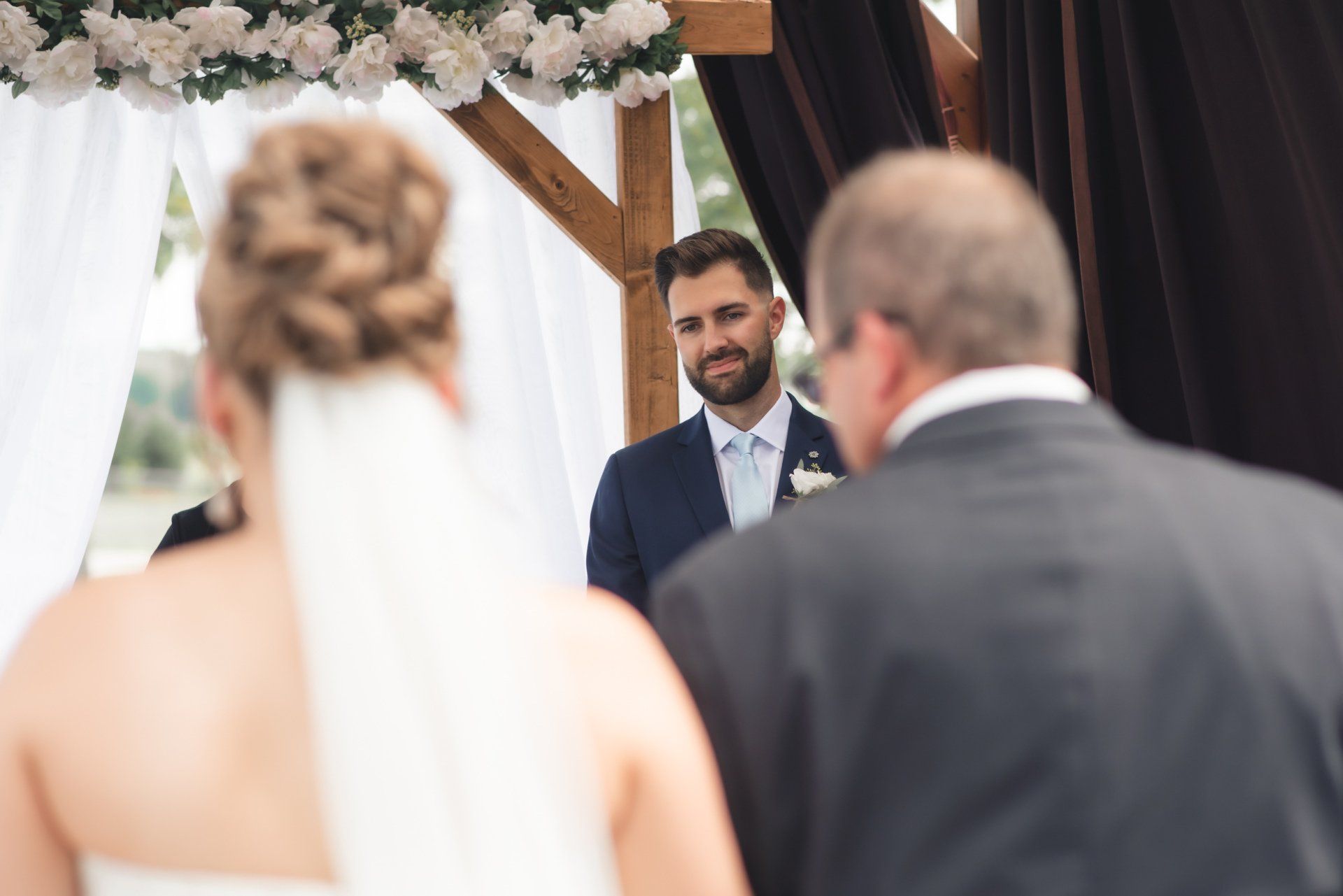 A bride and groom are standing at the altar during their wedding ceremony.