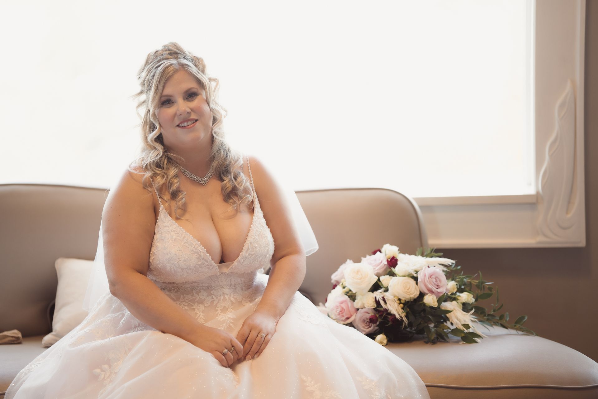 Portrait of bride sitting beside bouquet in front of window, Retro Suites Hotel, vintage wedding