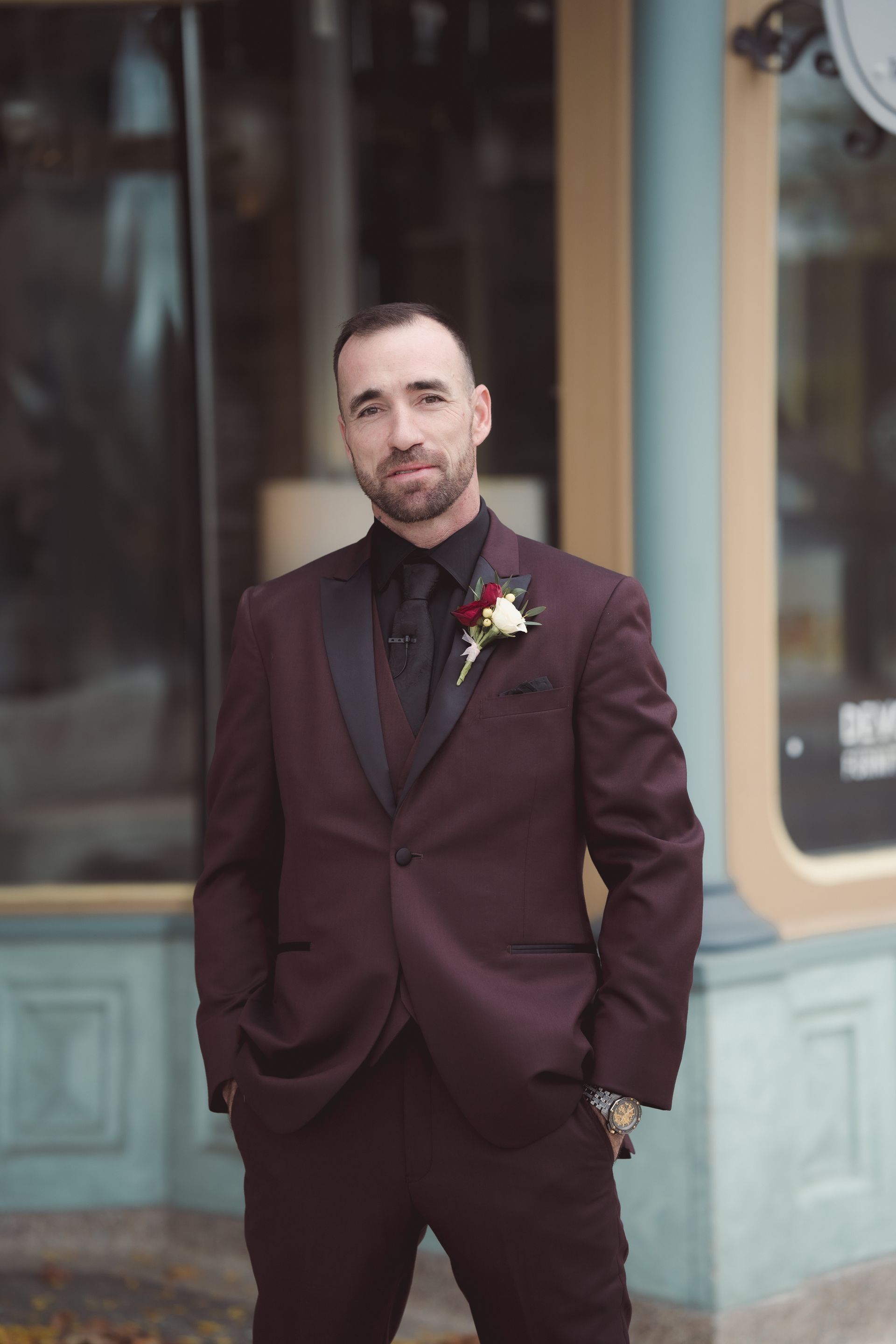 portrait of Groom on sidewalk in front of the storefront, Retro Suites Hotel, vintage wedding