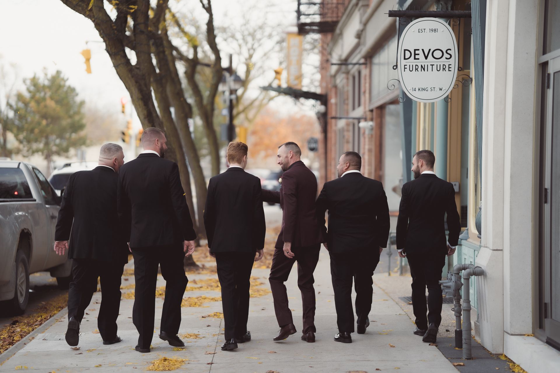 groom and groomsmen walking in front of stores downtown, Retro Suites Hotel, vintage wedding