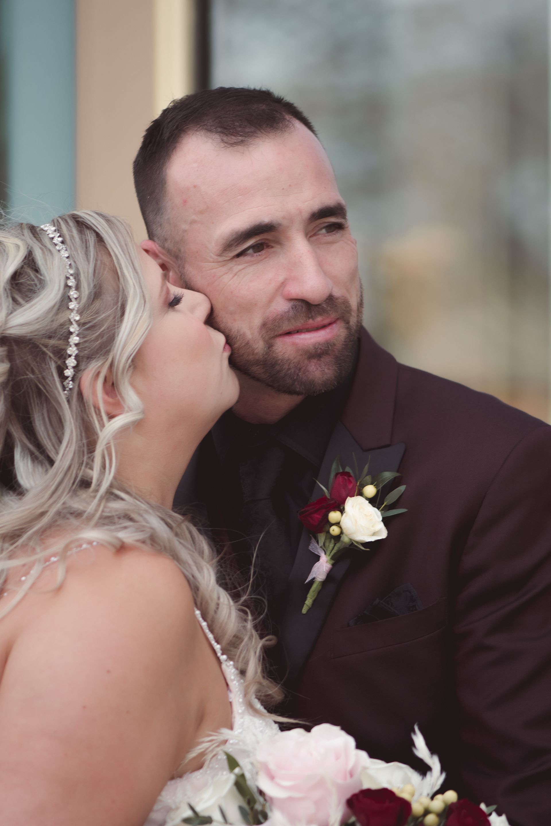 Portrait of bride and groom, bride, kissing groom on cheek, Retro Suites Hotel, vintage wedding