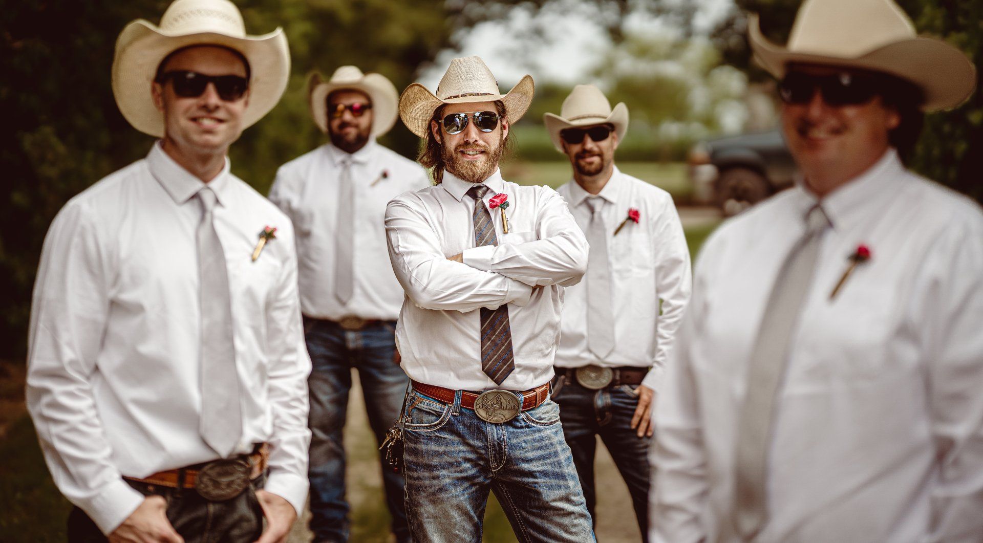 A group of men wearing cowboy hats and ties are standing next to each other.