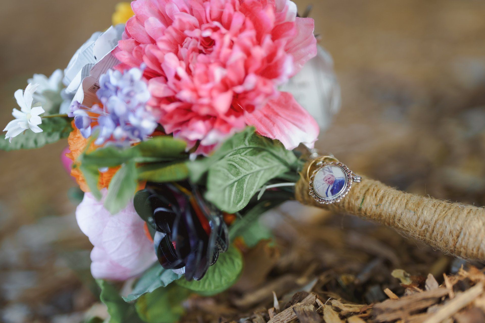 A close up of a bouquet of flowers with a ring on it.