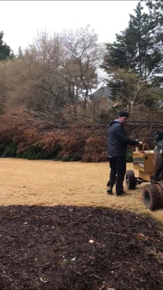 A man is standing next to a tractor in a field.