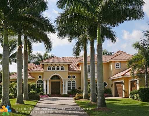 charming driveway entry to luxurious Gated Boynton home