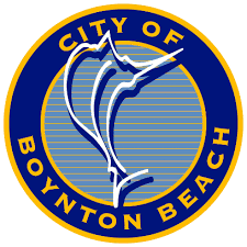 A young boy is sitting on a seesaw in a park.