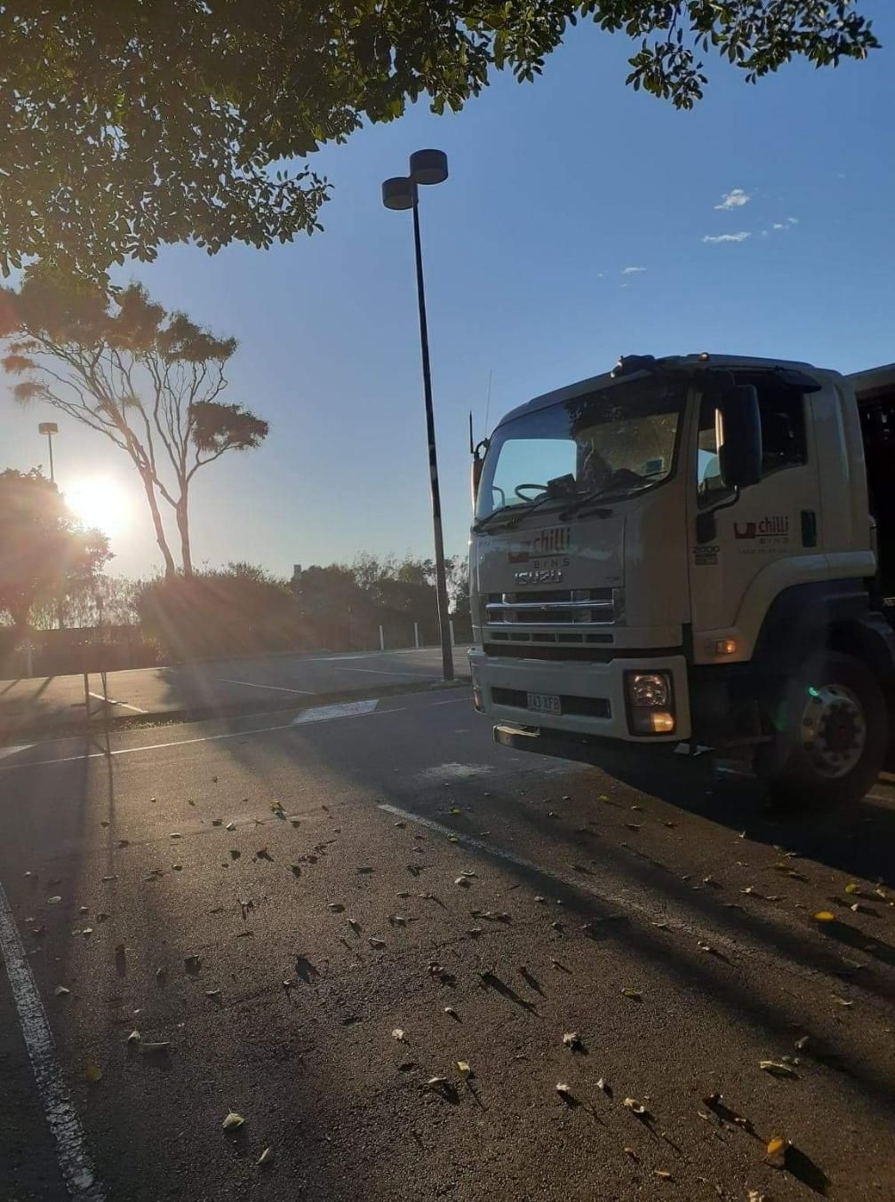 A Truck Is Parked on The Side of The Road — Chilli Bins Skip Bins in Glenview, QLD