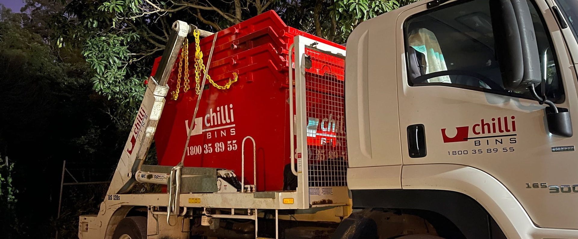 A Red Dumpster On Back Of Truck — Chilli Bins Skip Bins in Noosa, QLD