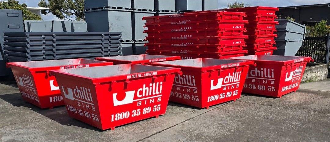 Red Chilli Bins are arranged with a stack of red bins in the background