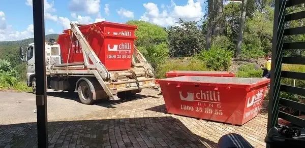 Four Red Skip Bins Out The Front Of Yard — Chilli Bins Skip Bins in Glenview, QLD