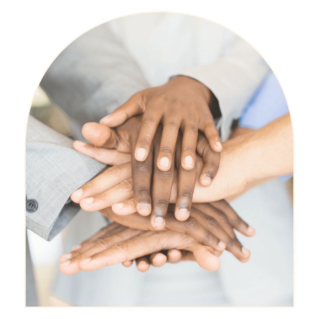 Hands of diverse people stacked in a group, symbolizing teamwork and unity.