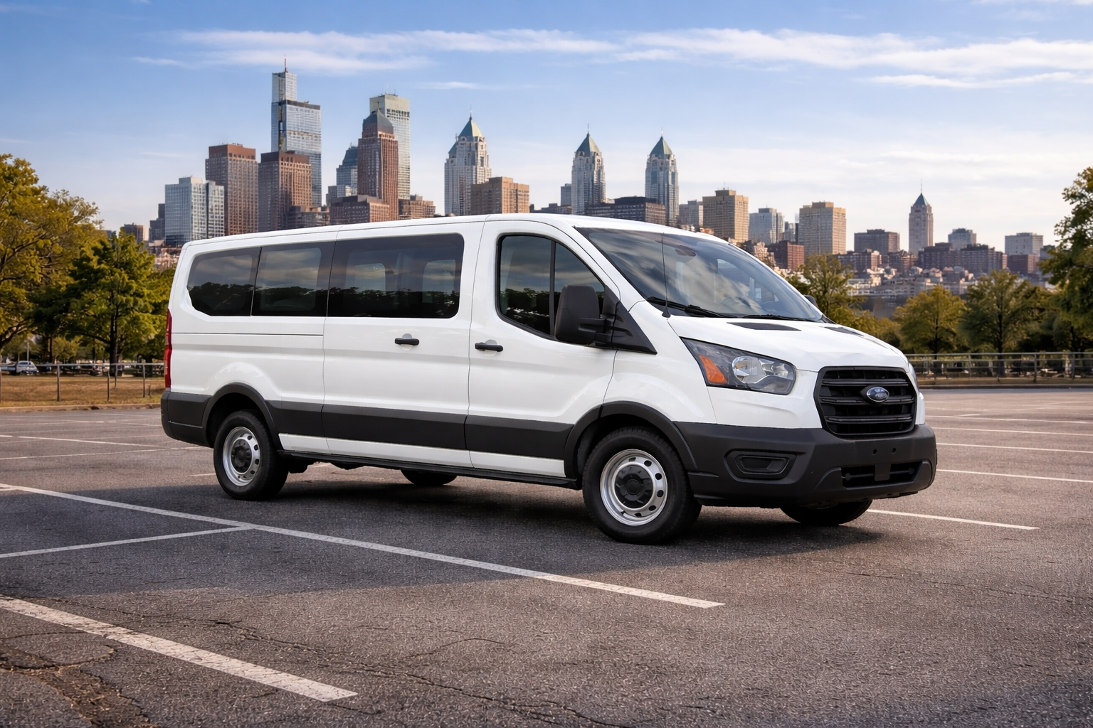 White Ford Transit van from White Auto Rental Inc parked in a lot, with the Philadelphia skyline in the background.