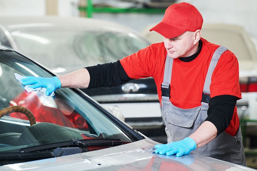 a man waxing a car in a garage