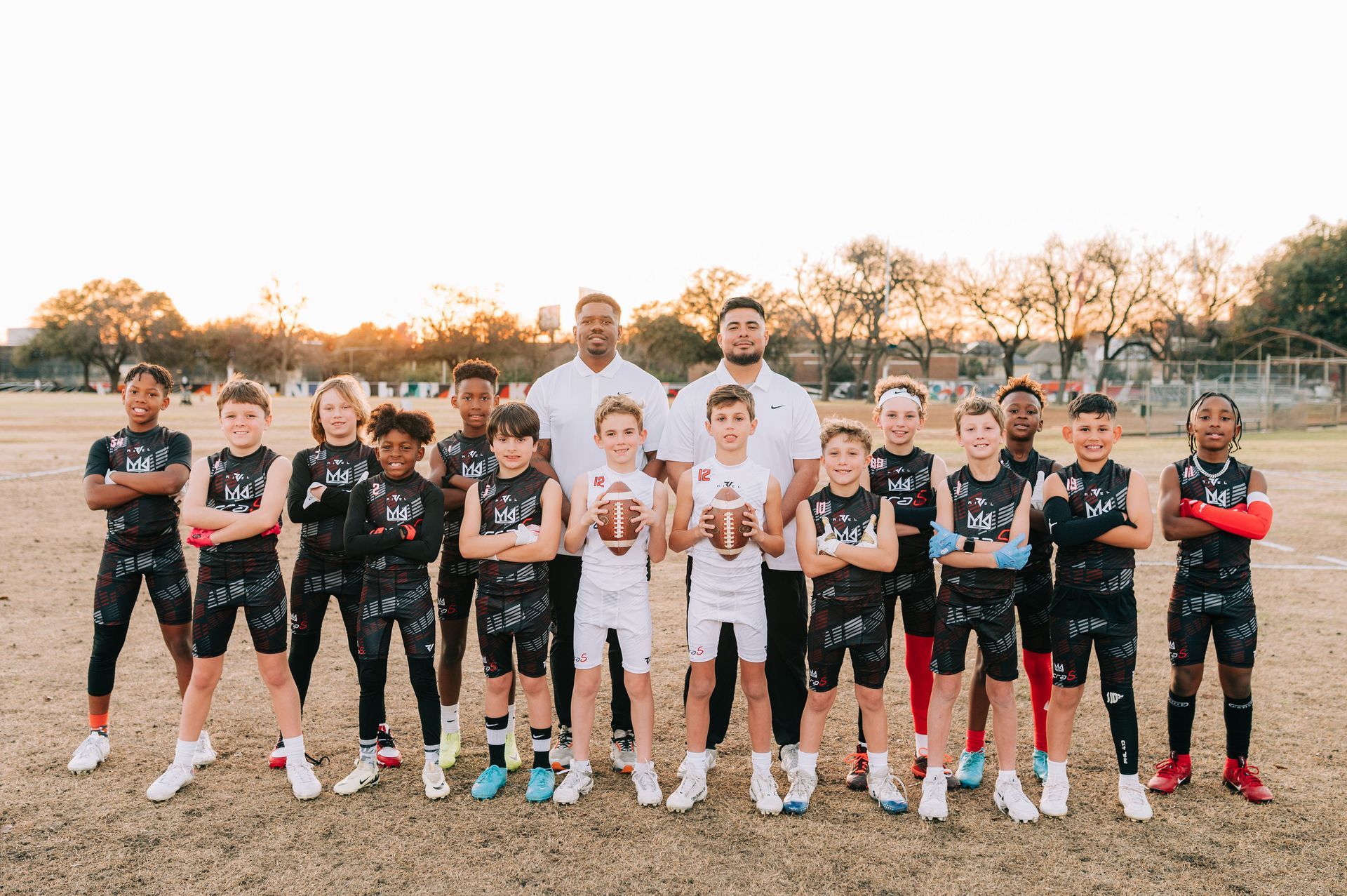 A football is sitting on the corner of a football field in a stadium.