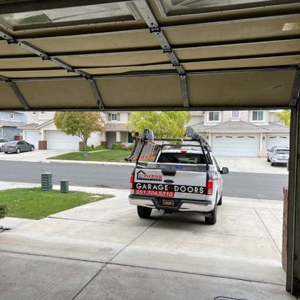A truck is parked in a garage door.