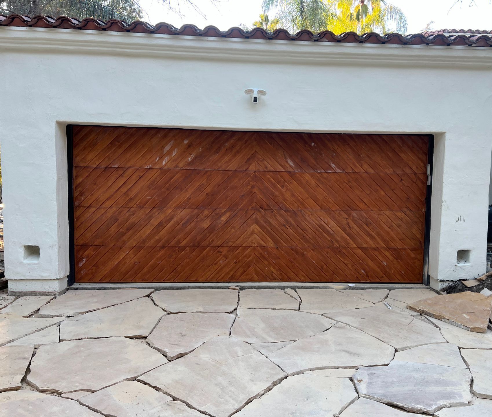 A white garage with a wooden garage door