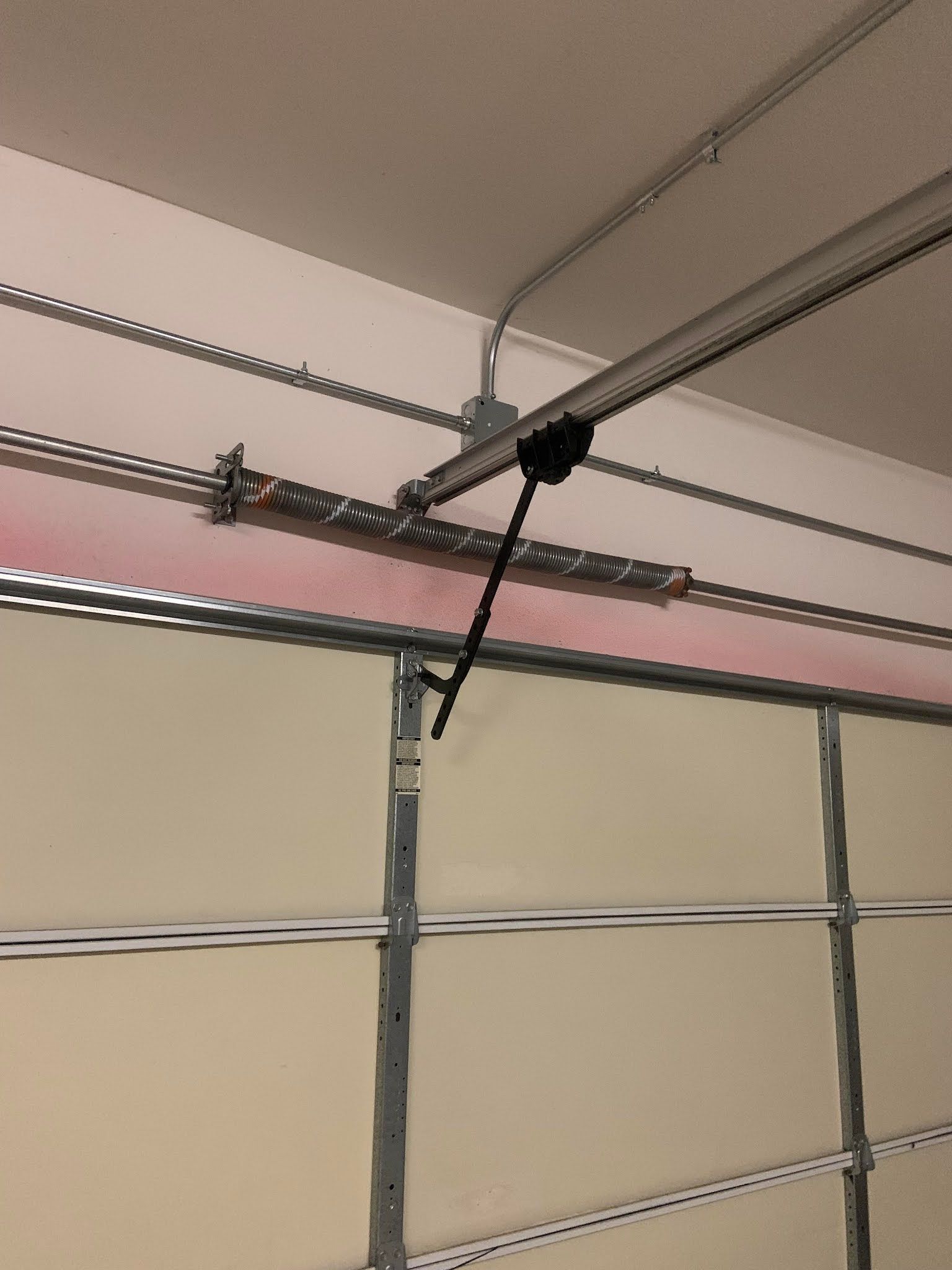 A close up of a garage door with a broken spring.