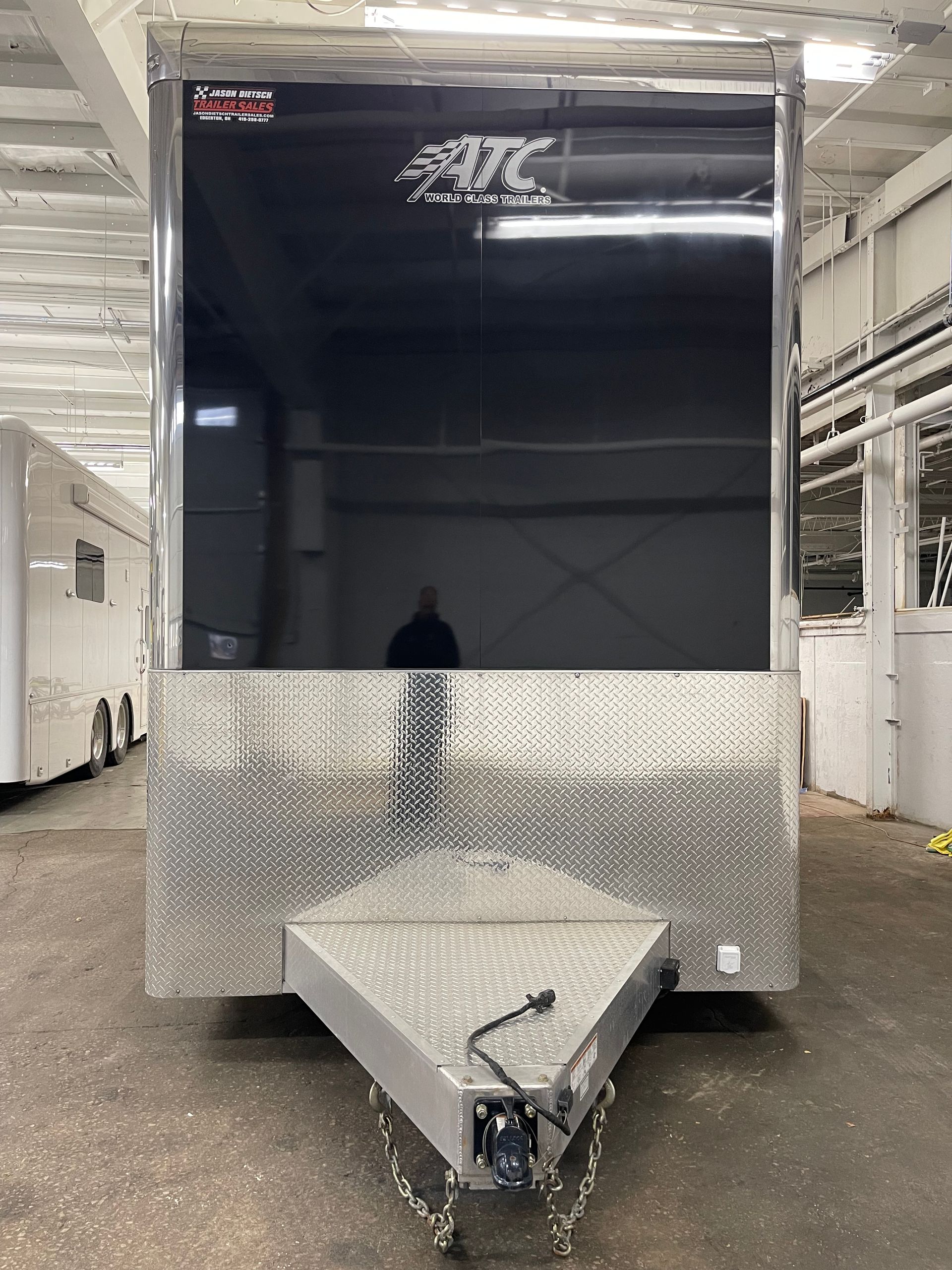 Front view of a black and silver enclosed cargo trailer.