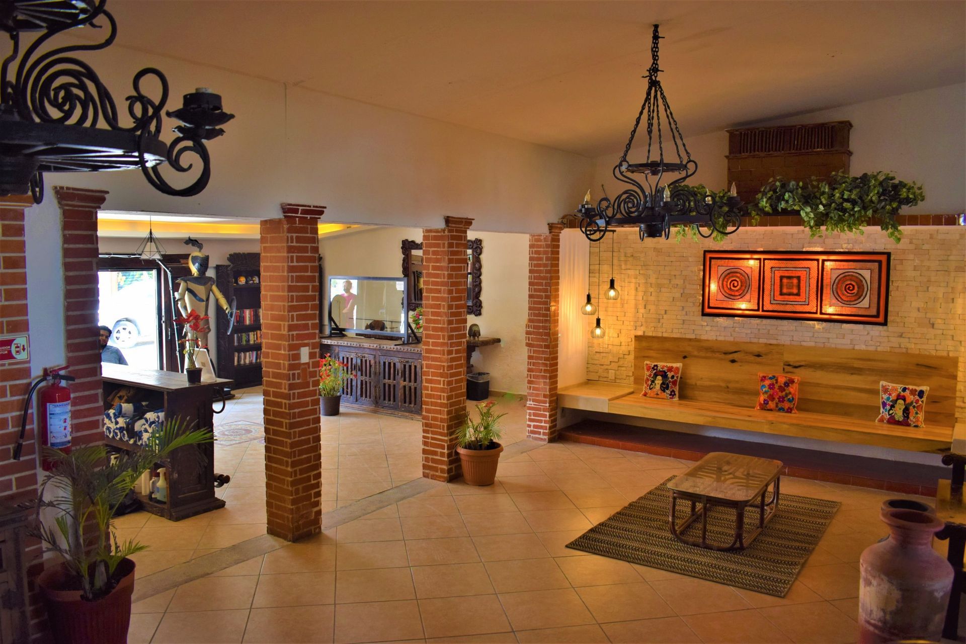 Lobby with brick columns, seating, art, and a bar.