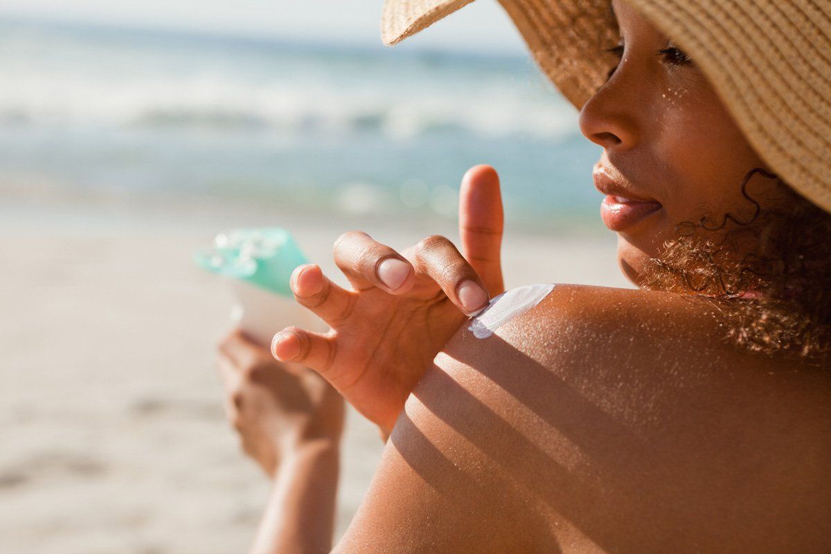 Applying Sunscreen on Her Shoulder — Australia — Sunsational Sunscreen