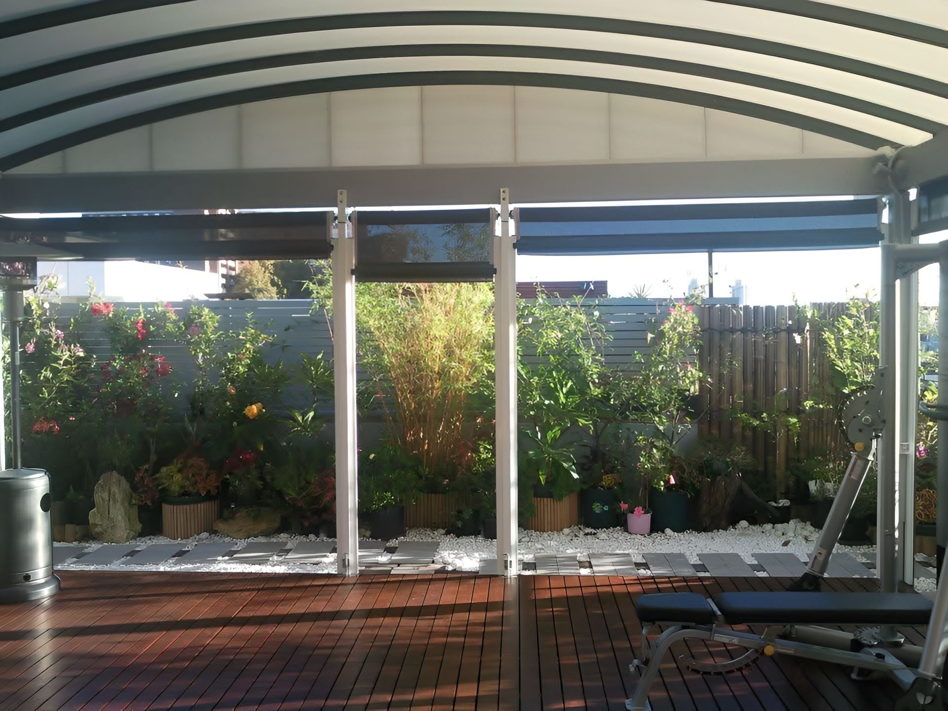 Carport attached to a white house; gray roof, light frame, shrubbery in front. — Truecraft Services in Biboohra, QLD