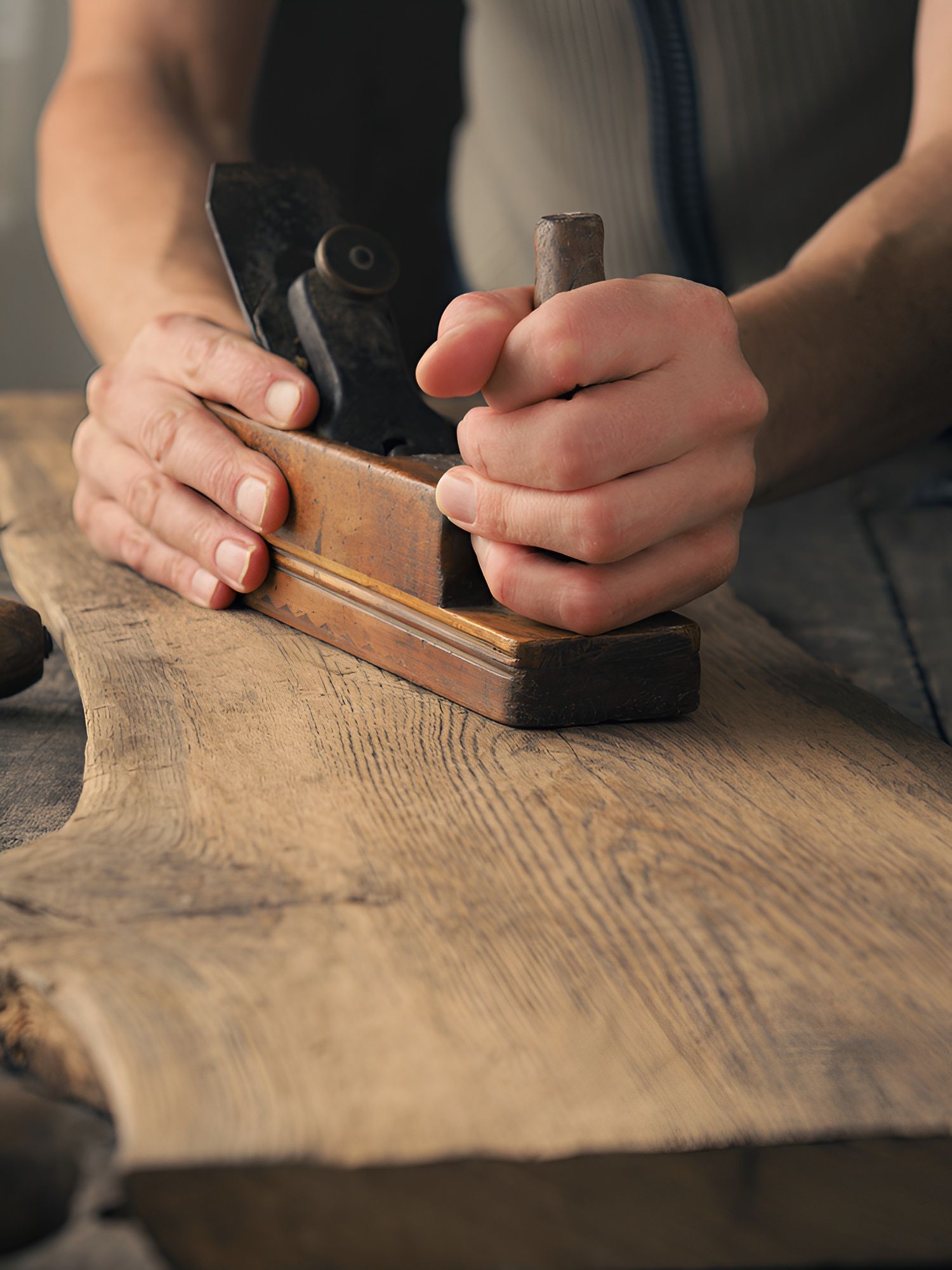 Hands Planing a Wooden Board — Truecraft Services in Biboohra, QLD