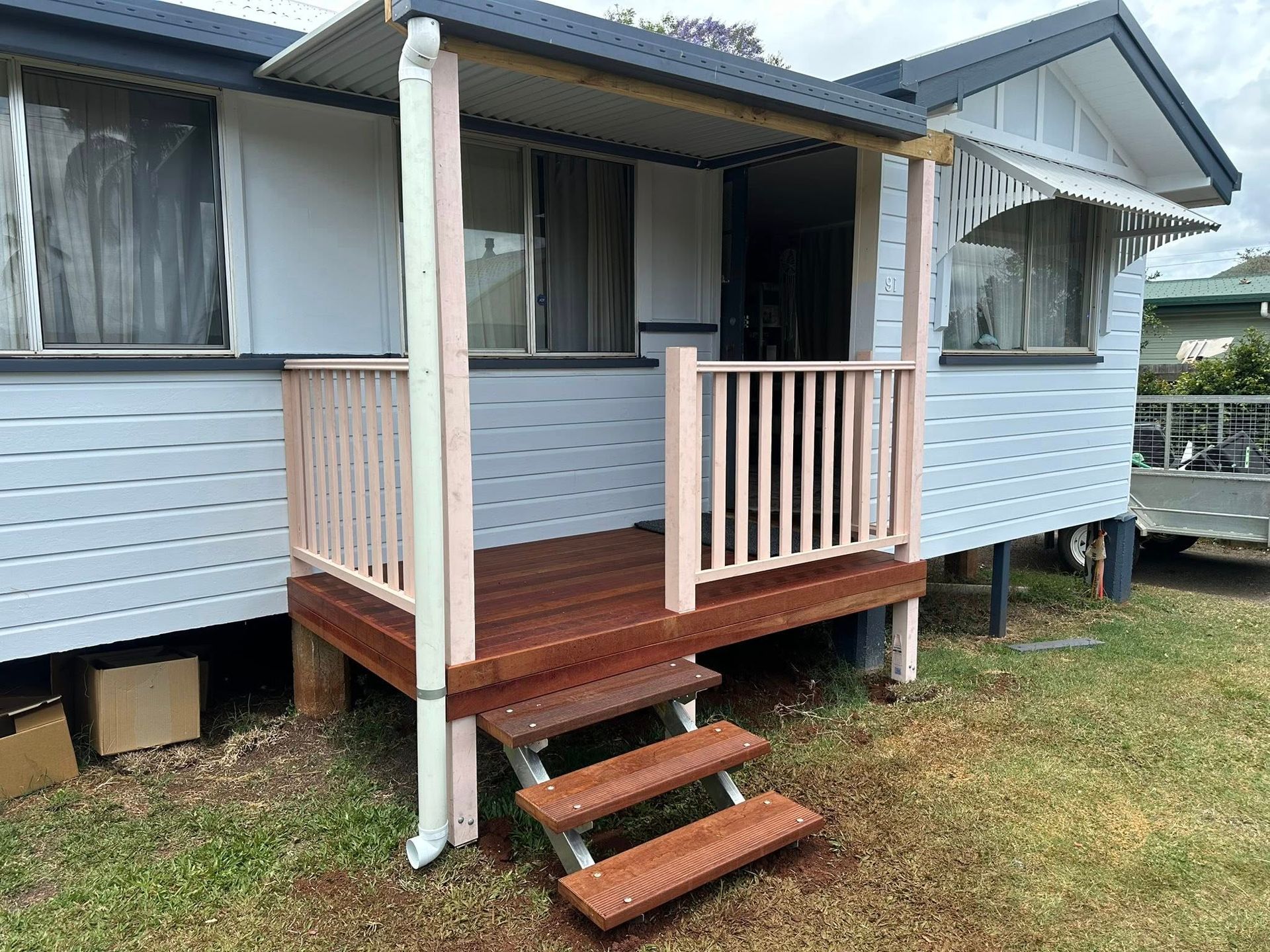 Small House With a Wooden Deck, Stairs, and Railing — Truecraft Services in Biboohra, QLD