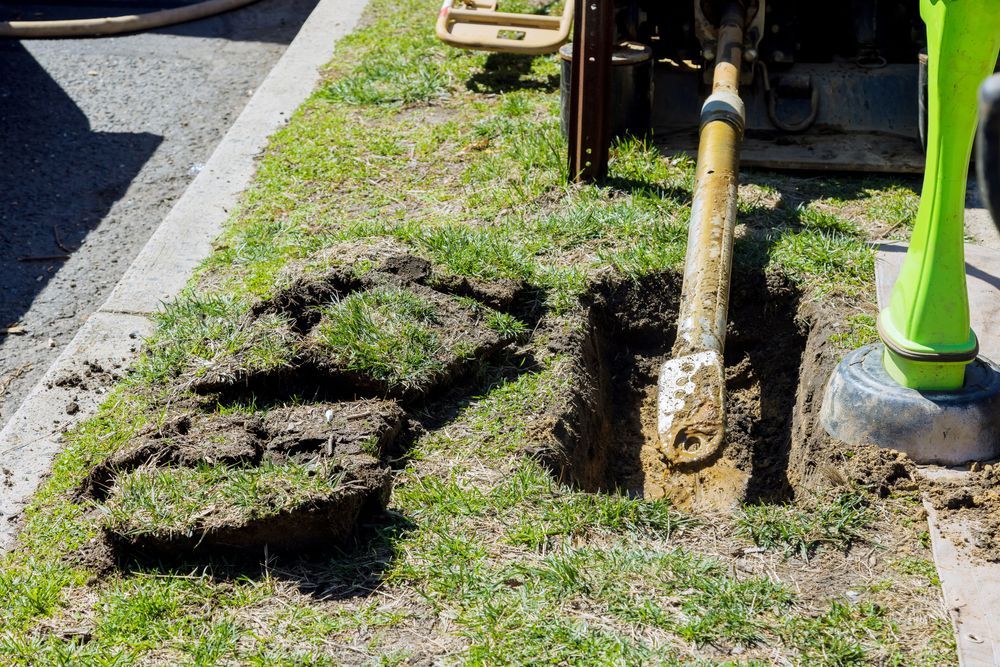 A shovel is sticking out of a hole in the ground.