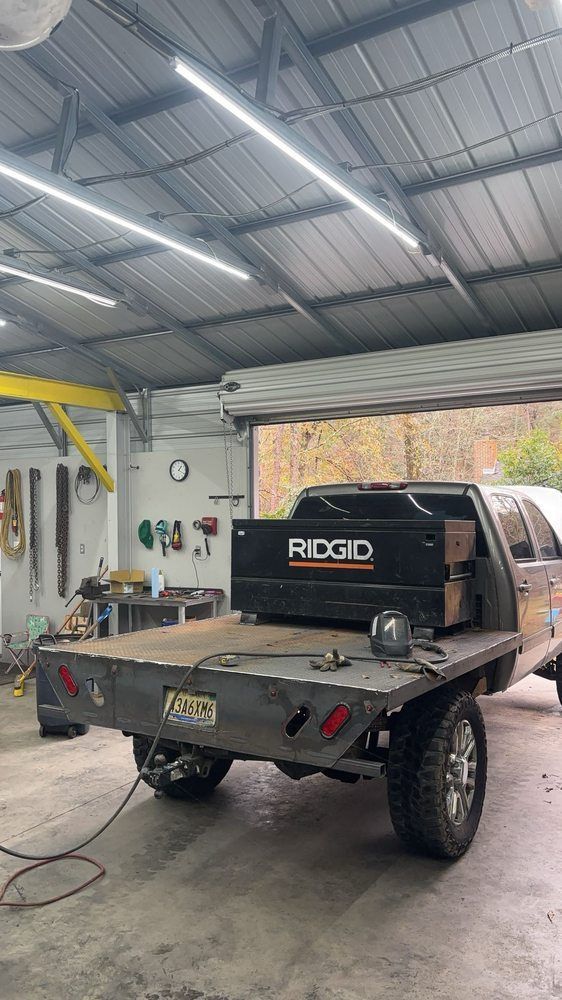 Flatbed truck with RIDGID toolbox in a workshop.