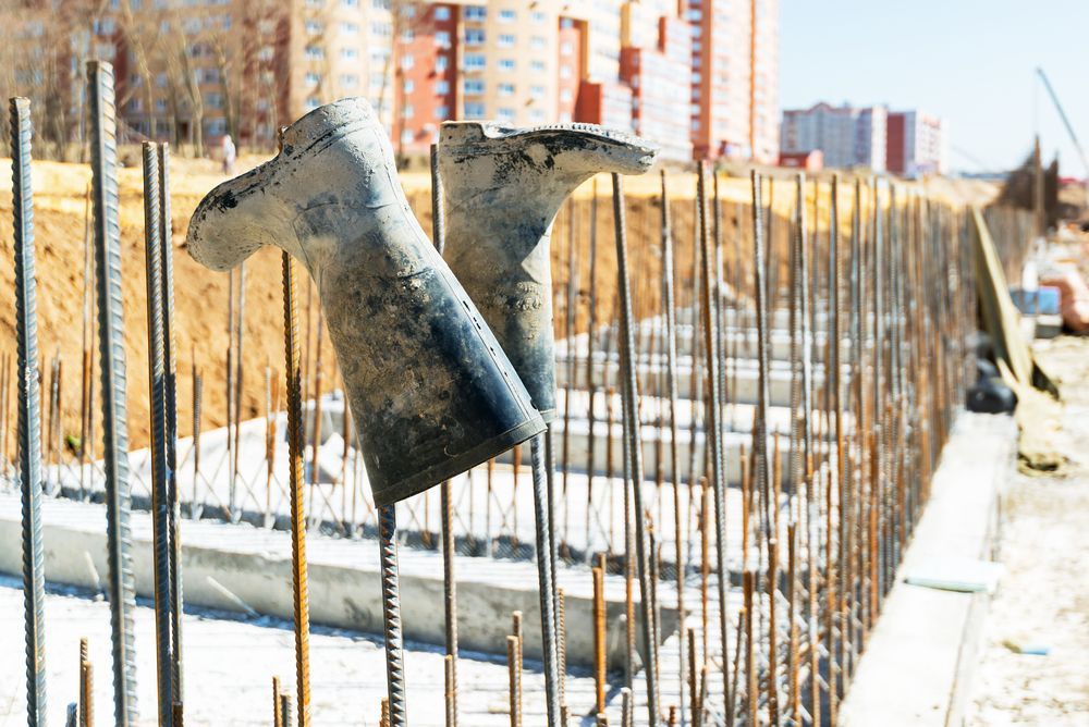 Truck bed side constructed from welded metal, with tire and ground visible.