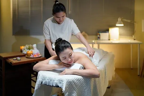 Woman relaxing during a professional home spa massage.