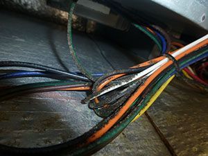 A bunch of wires are tied together on a wooden table.