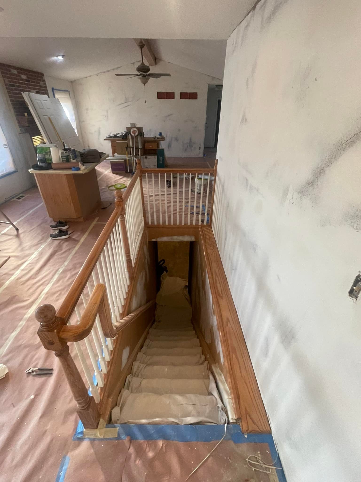 A wooden staircase leading up to a basement in a house.
