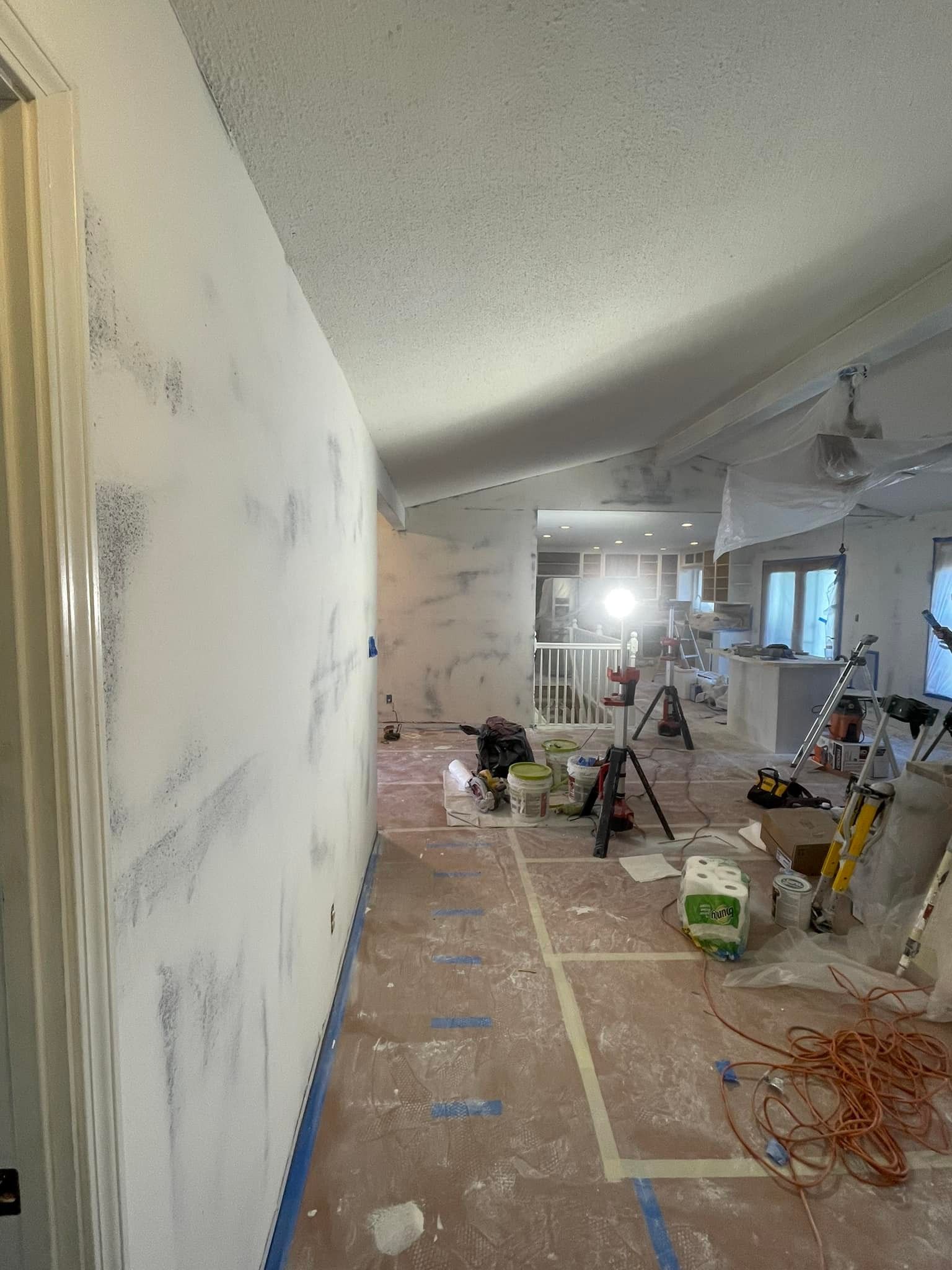A hallway is being painted in a house.