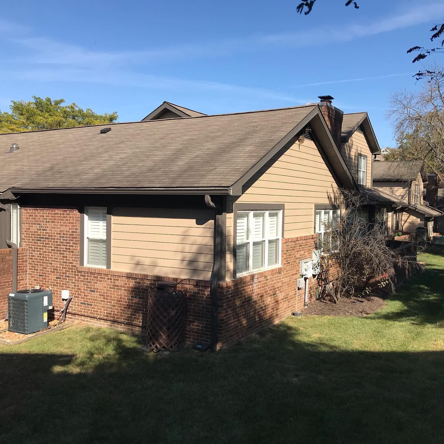A house with a brown roof and a lot of windows