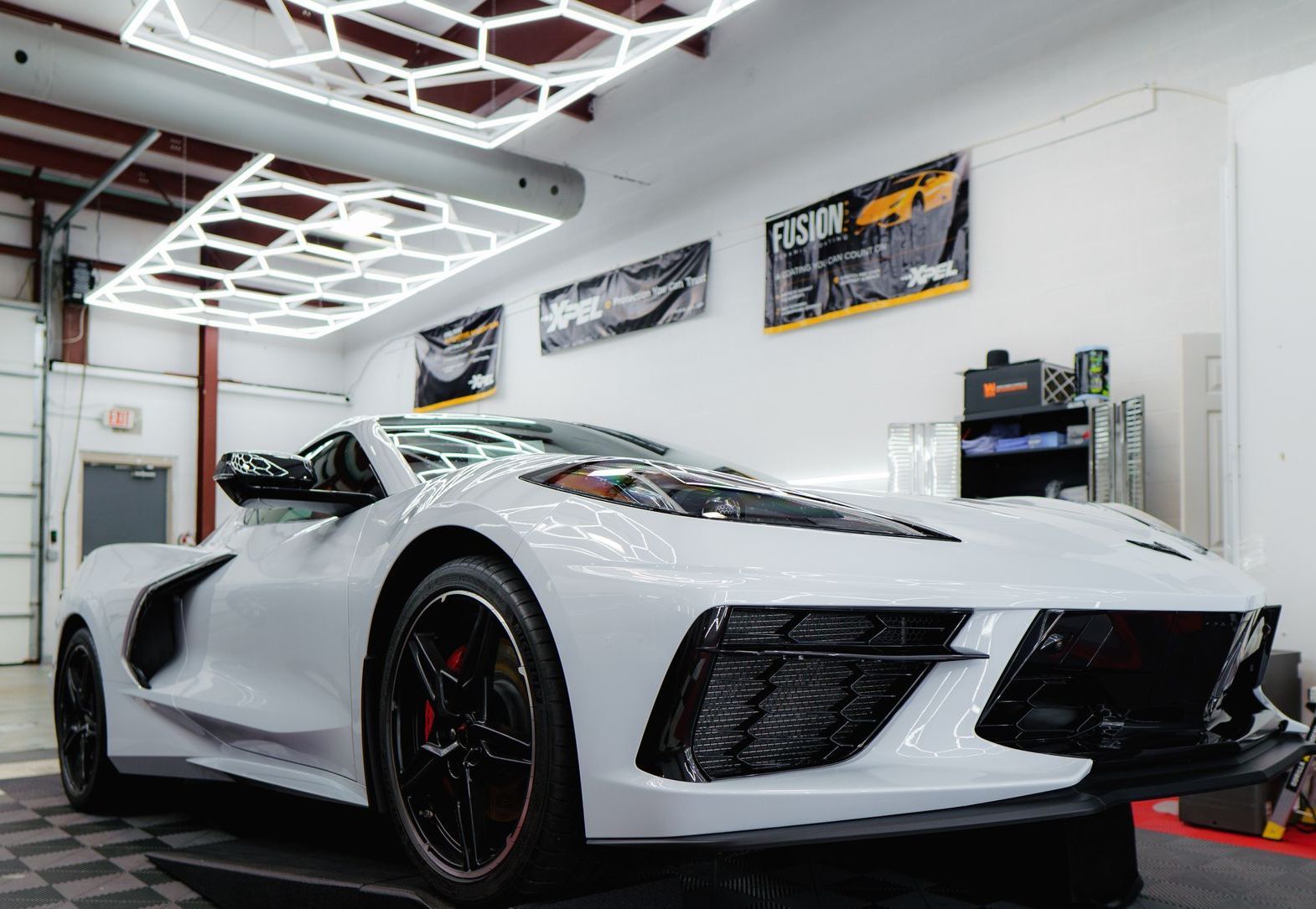 a white sports car is parked in a garage .