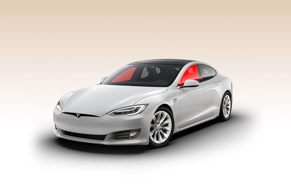 a white tesla model s with a red windshield on a white background .