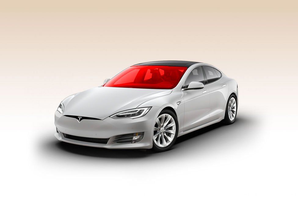 a white tesla model s with a red windshield on a white background .