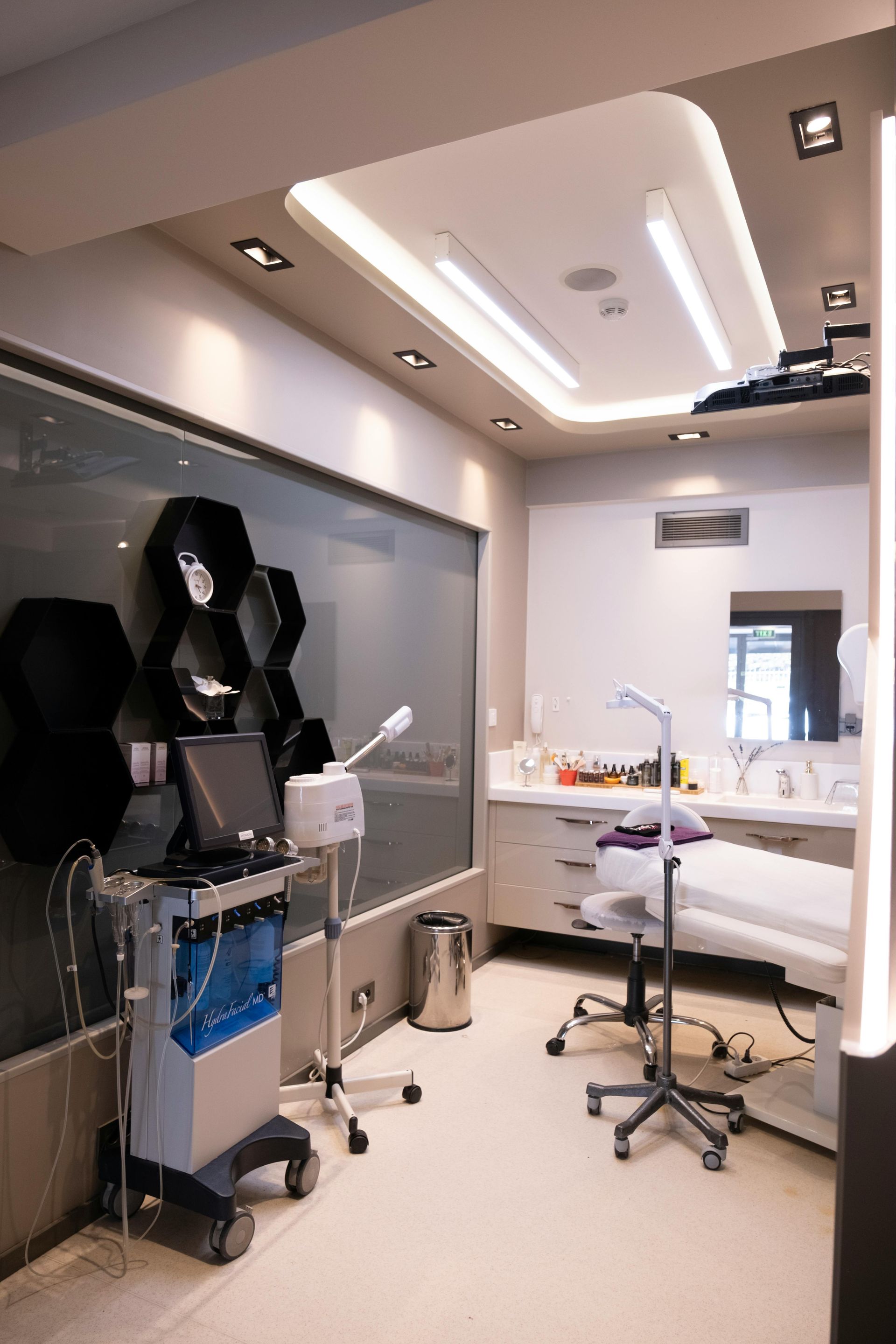 Modern dental exam room with chair, tools, and overhead lights