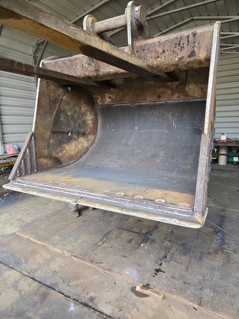 Large, rusty excavator bucket.