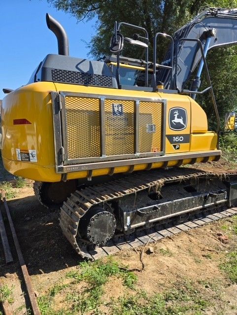 Yellow John Deere 200 excavator on tracks; parked outdoors.