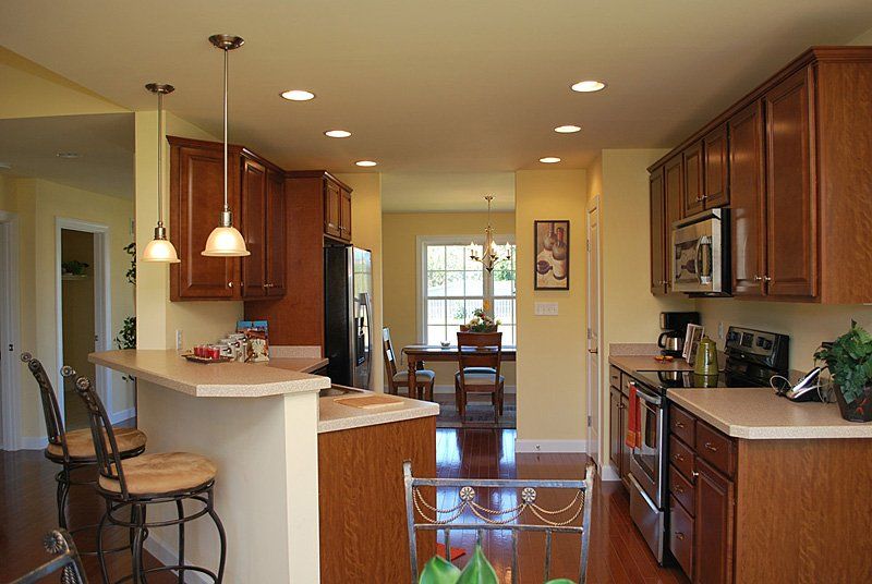 A kitchen with wooden cabinets and stainless steel appliances