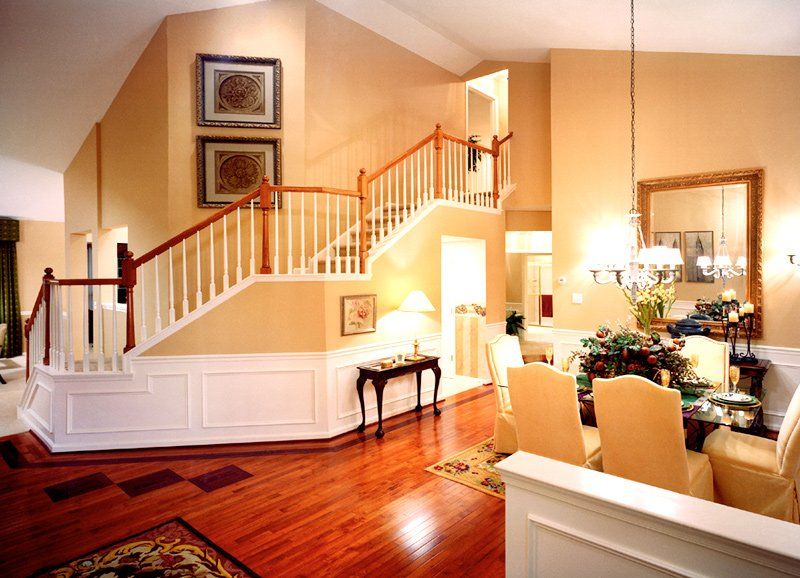 A living room with a staircase leading up to the second floor