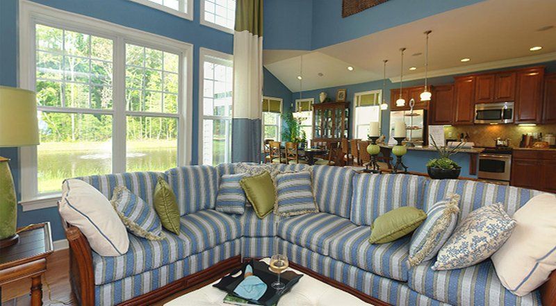 A living room with a blue and white striped sectional couch.