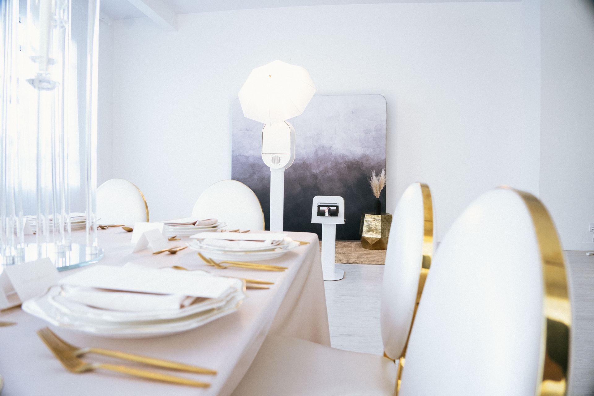 A dining room table with plates , silverware , and chairs.