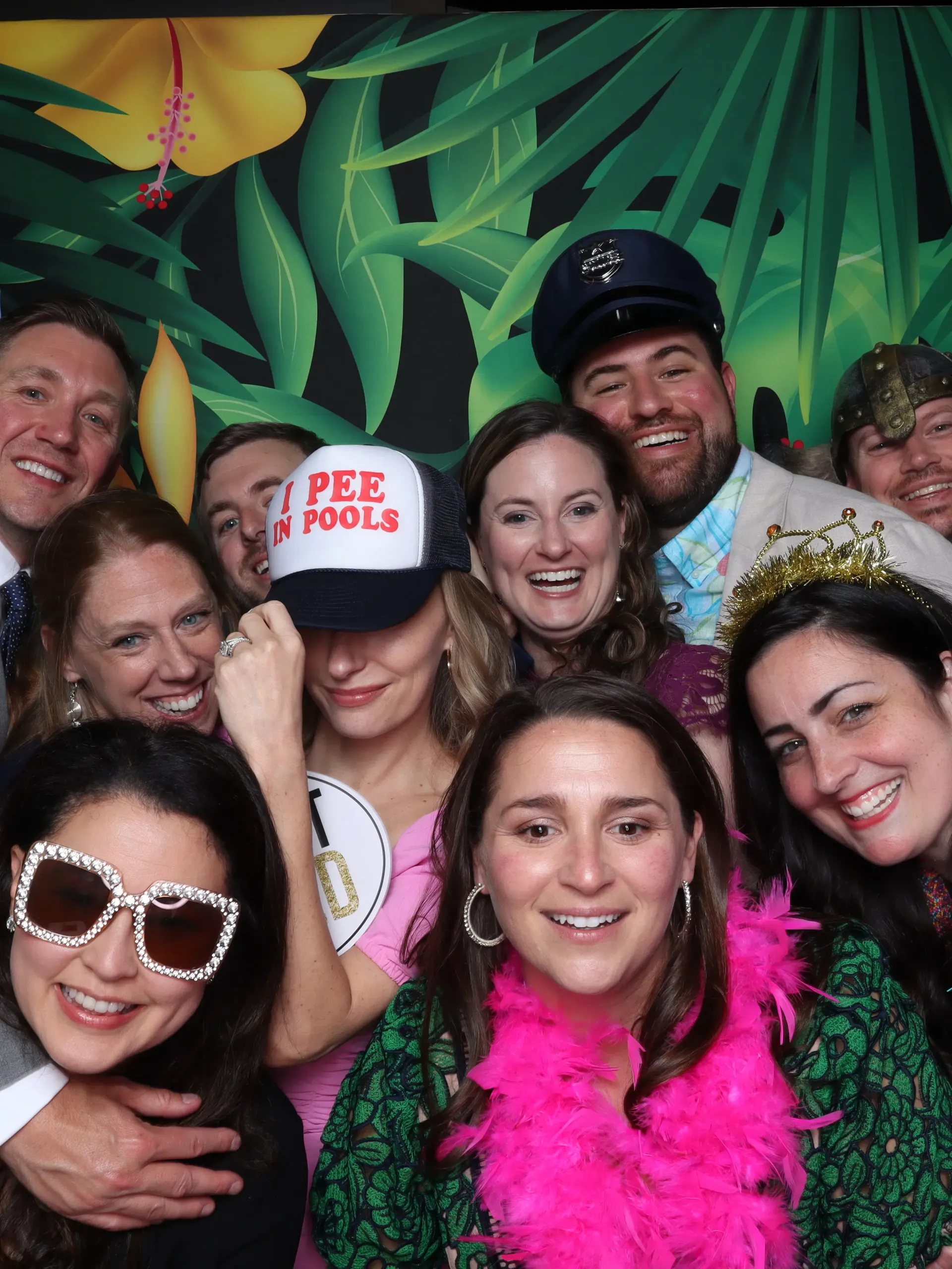A group of friends posing for a picture in a 302 photo booth.
