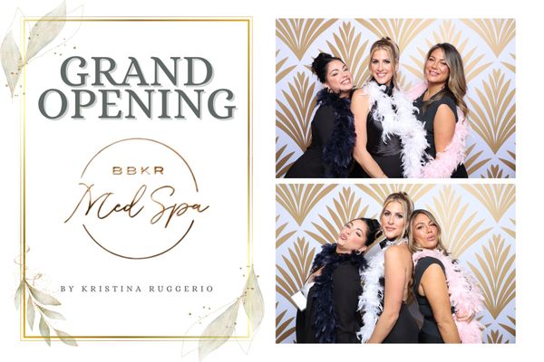 A group of women are posing for a picture in a photo booth for a grand opening.