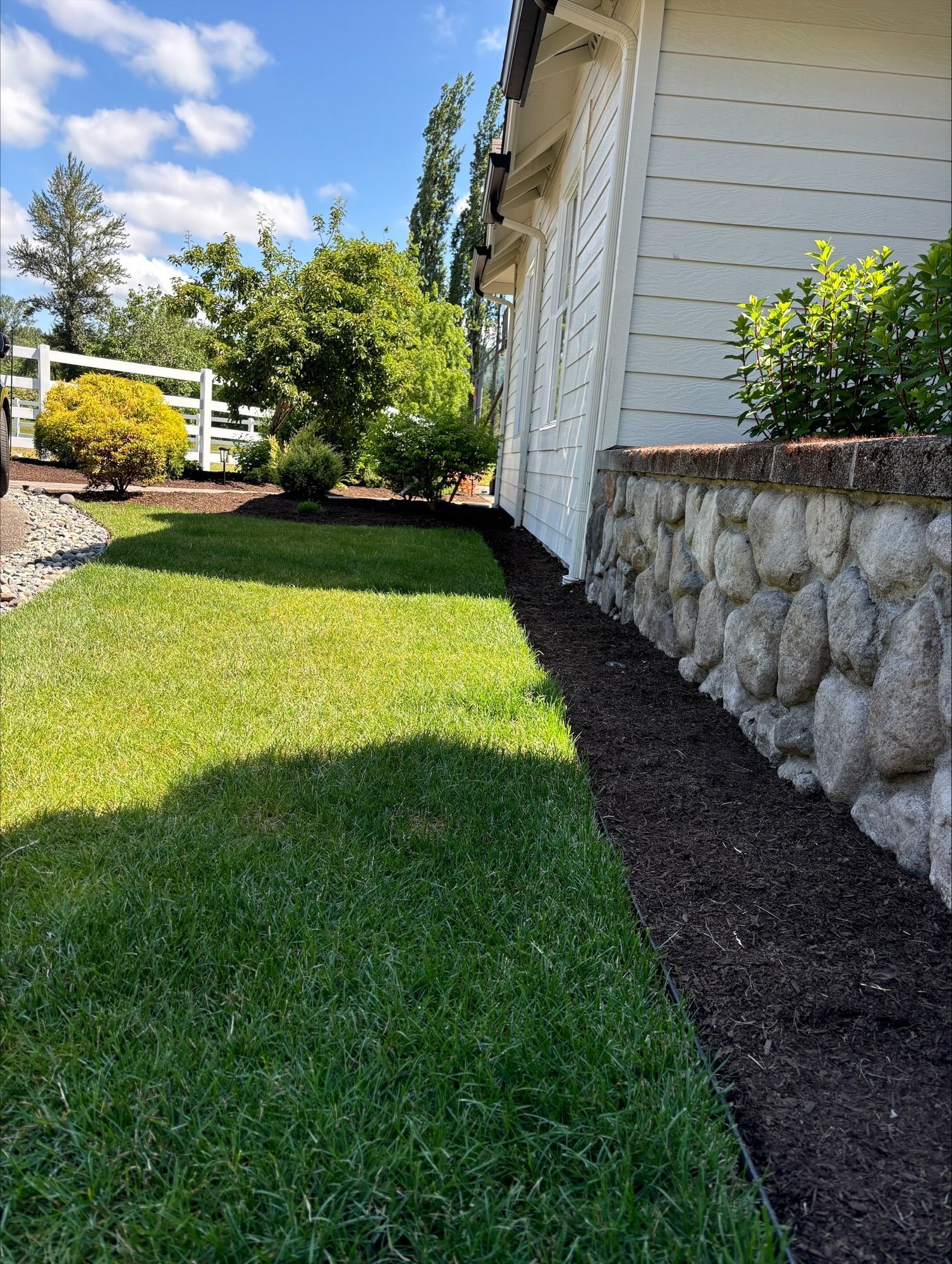 A roll of turf is sitting on top of a lush green lawn.