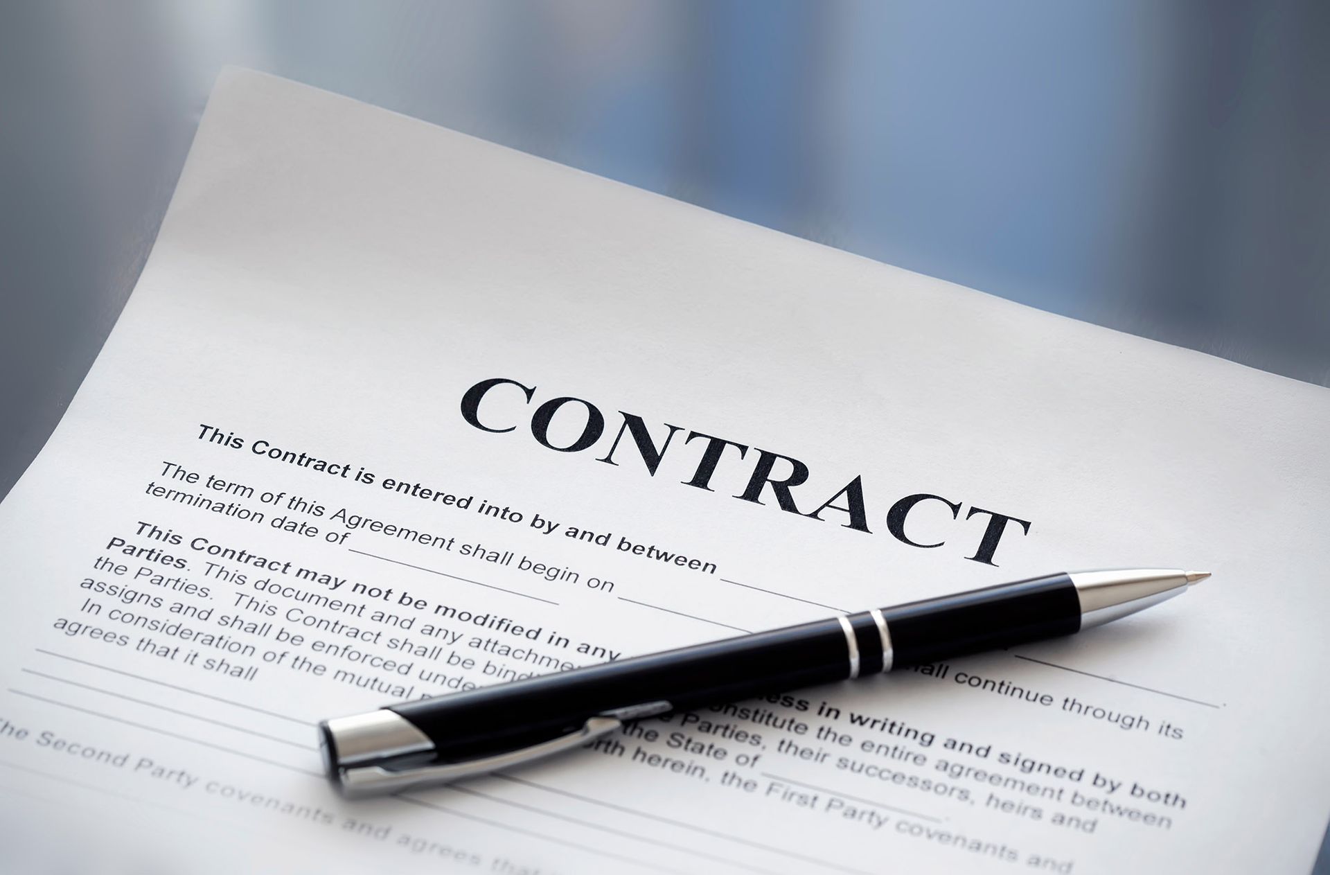 Contract document with a pen, ready to be signed.